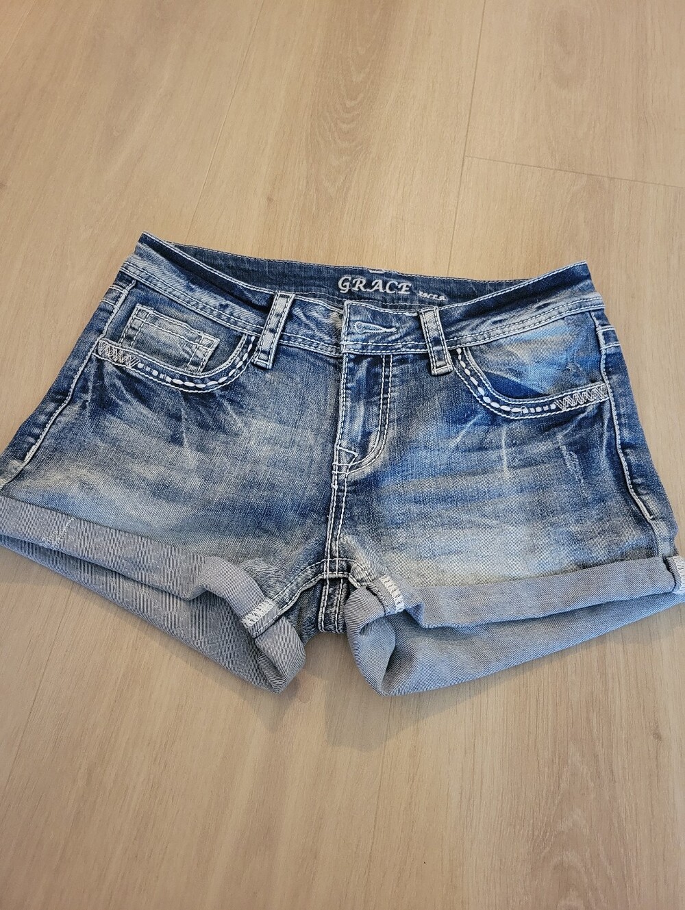 Grace In LA Distressed Light Blue Denim Roll-Cuff Shorts
